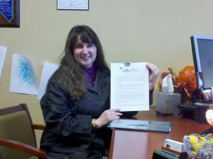 April signing her book publishing contract with LeRue Press for THE ALTERED I